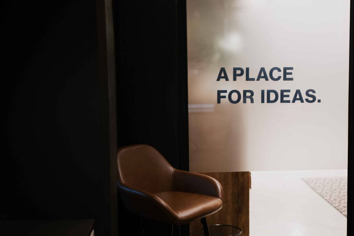 A glass-walled breakout room etched with the words &lsquo;A place for ideas&rsquo;.